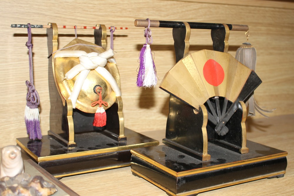 A Japanese late Meiji period composition and fabric figure of a boy farmer holding an adze with puppy seated nearby, mounted on display